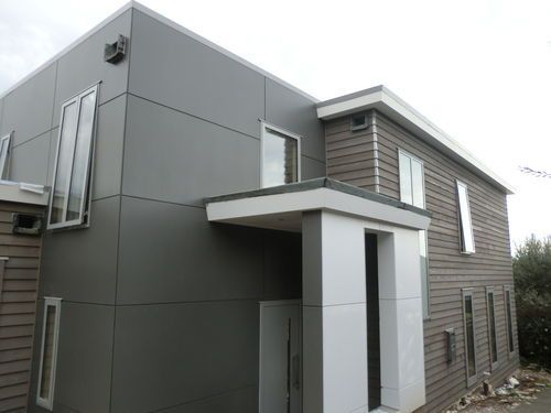 Ngaiwi st, Orakei. Leaky home renovation and reclad with negative detailed titan board and cedar weatherboards.Photo shows almost finished