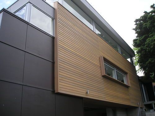 Bay rd, St Heliers bay. New house clad with Maranti plywood with horizontal batten and rusticated cedar weatherboard