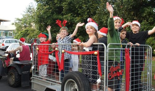 Santa's helpers wave to the crowd