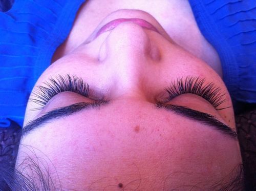 Customized semi-permanent lashes, filled in with additional lashes to create a luxurious look
