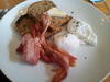 <p>
Yummy poached eggs on grainy toast with a side of succulent bacon</p>