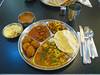 Thaali Combo: Chappati, Rice, Dhal Soup, Vegetable Curry, Paneer Curry, Papadam, Pakoras with Chutney, Halva Dessert 